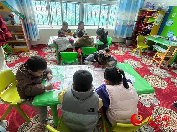 拉多村一所現(xiàn)代化幼兒園小班孩子們正在繪畫。張敏穎 攝